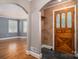 Inviting foyer with arched doorways, hardwood floors, and a decorative front door at 1220 Oakwood Ave, Gastonia, NC 28052