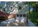 Attached garage with white carriage doors and a convenient driveway for easy access and parking at 1220 Oakwood Ave, Gastonia, NC 28052