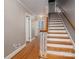 Hallway featuring hardwood floors, stairs, and access to multiple rooms at 1220 Oakwood Ave, Gastonia, NC 28052
