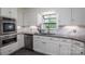 Updated kitchen featuring stainless appliances and marble backsplash at 1220 Oakwood Ave, Gastonia, NC 28052