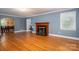 Inviting living room featuring a fireplace, hardwood floors, and an open layout at 1220 Oakwood Ave, Gastonia, NC 28052