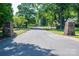 Street view of Brookwood community, featuring stone entrance signs, mature trees, and well-maintained lawns at 1220 Oakwood Ave, Gastonia, NC 28052
