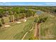 Breathtaking aerial view of lush golf course and community, with winding paths and serene ponds at 12531 Kane Alexander Dr, Huntersville, NC 28078