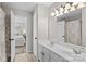 Bathroom with double sinks and mirrors with an open doorway to the bedroom at 12531 Kane Alexander Dr, Huntersville, NC 28078