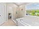 Bright bathroom with a walk-in shower, soaking tub and window with a green view at 12531 Kane Alexander Dr, Huntersville, NC 28078