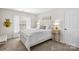 Serene bedroom featuring neutral tones, a queen bed, and a window with natural light at 12531 Kane Alexander Dr, Huntersville, NC 28078