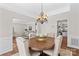 Dining room showcasing a wooden table, neutral-toned chairs, chandelier lighting, and access to living room at 12531 Kane Alexander Dr, Huntersville, NC 28078