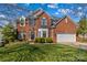 Beautiful two-story brick home with manicured lawn and attached two-car garage, enhancing curb appeal at 12531 Kane Alexander Dr, Huntersville, NC 28078