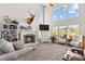 Bright living room with high ceilings, fireplace, and large windows overlooking the deck at 12531 Kane Alexander Dr, Huntersville, NC 28078