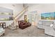 Inviting living room featuring a staircase, comfortable seating, and ample natural light at 12531 Kane Alexander Dr, Huntersville, NC 28078