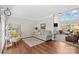 Comfortable living room showcasing hardwood floors, a cozy sofa, accent chair, and natural light at 12531 Kane Alexander Dr, Huntersville, NC 28078