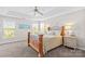 Serene main bedroom with tray ceilings, plush bedding, and lots of natural light at 12531 Kane Alexander Dr, Huntersville, NC 28078