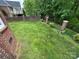 Well-maintained backyard with lush green grass, brick accents, and a secure fence at 127 Victoria Park Dr, Shelby, NC 28150