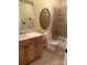 Bathroom vanity with oval mirror next to a tiled shower at 127 Victoria Park Dr, Shelby, NC 28150