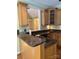 Granite countertops adorn this kitchen with eat-in bar and wooden cabinets at 127 Victoria Park Dr, Shelby, NC 28150