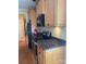 Well-lit kitchen with wooden cabinetry, dark appliances, and granite countertops at 127 Victoria Park Dr, Shelby, NC 28150