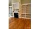 Living room featuring hardwood floors, fireplace and built in shelving at 127 Victoria Park Dr, Shelby, NC 28150