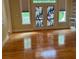 Living room featuring hardwood floors, windows, and a bookshelf at 127 Victoria Park Dr, Shelby, NC 28150