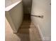 Carpeted staircase with handrail leads to the lower level of the home at 127 Victoria Park Dr, Shelby, NC 28150