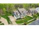 Stunning aerial view showcasing the home's manicured landscaping, spacious driveway, and architectural details at 13713 Sunset Bluffs Cir, Huntersville, NC 28078