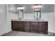 Bathroom featuring a double sink vanity with granite countertop and dark wood cabinets at 13713 Sunset Bluffs Cir, Huntersville, NC 28078