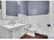 Elegant half bathroom with paneled walls, hardwood floors, and a classic pedestal sink at 13713 Sunset Bluffs Cir, Huntersville, NC 28078