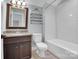 Bright bathroom with a granite vanity top, stylish dark wood cabinets, and a tiled shower over tub at 13713 Sunset Bluffs Cir, Huntersville, NC 28078