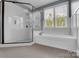 Bright bathroom featuring tiled shower, soaking tub and window views at 13713 Sunset Bluffs Cir, Huntersville, NC 28078