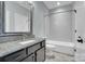 Well-lit bathroom featuring stone counter, dark wood cabinets, toilet and shower at 13713 Sunset Bluffs Cir, Huntersville, NC 28078