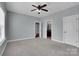 Neutral bedroom with carpet, ceiling fan, and connected bathroom and closet at 13713 Sunset Bluffs Cir, Huntersville, NC 28078