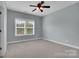 Bedroom featuring neutral carpet, ceiling fan and bright natural light at 13713 Sunset Bluffs Cir, Huntersville, NC 28078