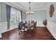 Traditional dining room with a dark wood table, light fixture, and wainscoting at 13713 Sunset Bluffs Cir, Huntersville, NC 28078