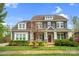 Charming two-story home featuring stone accents and a well-manicured lawn at 13713 Sunset Bluffs Cir, Huntersville, NC 28078