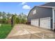 Home's side exterior with garage and basketball hoop at 13713 Sunset Bluffs Cir, Huntersville, NC 28078