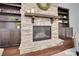 Close-up shot of a stone fireplace with built-in shelving and a decorative mantle at 13713 Sunset Bluffs Cir, Huntersville, NC 28078