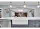 Kitchen island with large sink and seating opens to the living room at 13713 Sunset Bluffs Cir, Huntersville, NC 28078