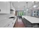 Bright, open kitchen with modern appliances and a large island with seating area at 13713 Sunset Bluffs Cir, Huntersville, NC 28078