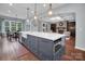Open concept kitchen features a large island with sink, dishwasher, and storage at 13713 Sunset Bluffs Cir, Huntersville, NC 28078