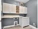 Well-lit laundry room featuring white cabinets, sink, and counter space at 13713 Sunset Bluffs Cir, Huntersville, NC 28078