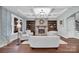 Warm living room featuring a stone fireplace, coffered ceiling, and stylish furnishings at 13713 Sunset Bluffs Cir, Huntersville, NC 28078