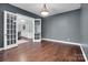 Open living room with hardwood floors and french doors leading to another room at 13713 Sunset Bluffs Cir, Huntersville, NC 28078