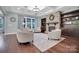 Cozy living room showcasing a stone fireplace, coffered ceiling, and built-in shelving at 13713 Sunset Bluffs Cir, Huntersville, NC 28078