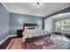 Main bedroom with hardwood floors, a ceiling fan, a large rug, and a sitting area at 13713 Sunset Bluffs Cir, Huntersville, NC 28078