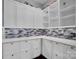 Walk-in pantry features ample shelving, storage cabinets and stylish tile backsplash at 13713 Sunset Bluffs Cir, Huntersville, NC 28078