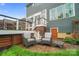 Cozy patio with wicker chairs and side tables, complemented by the house's exterior at 13713 Sunset Bluffs Cir, Huntersville, NC 28078