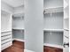 Spacious walk-in closet with ample shelving and drawer space, and hardwood floors at 13713 Sunset Bluffs Cir, Huntersville, NC 28078