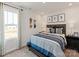 Cozy bedroom with a skateboard wall decor, a large window, and a striped comforter on the bed at 141 Shepherds Landing Dr, Mooresville, NC 28115