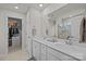 Bright bathroom featuring double sinks, a large mirror, and a walk-in shower with glass door at 15122 Lake Ridge Rd, Charlotte, NC 28278