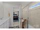 Bathroom with a shower and a view into a bedroom with a dark wood sleigh bed and natural light at 15122 Lake Ridge Rd, Charlotte, NC 28278