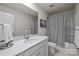 Clean bathroom featuring a bright vanity, shower with curtain, and tiled flooring providing a refreshing space at 15122 Lake Ridge Rd, Charlotte, NC 28278